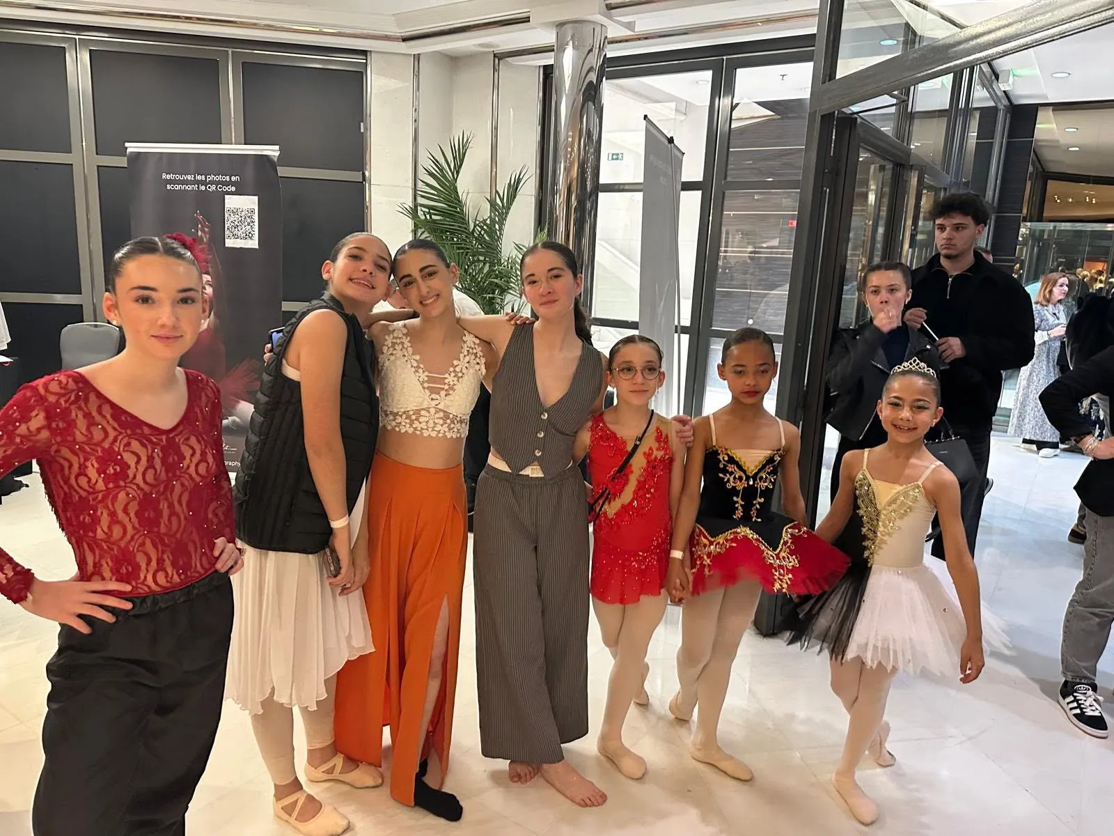Groupe d'élèves en costumes dans le hall avant leur passage en concours
